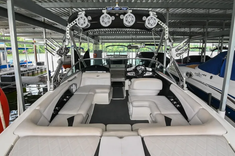 Slide: The Image of 2009 MasterCraft X-45 boat interior with spacious seating and advanced audio system in a covered dock. - 8