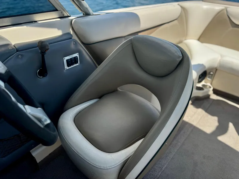 Slide: The Image of 2005 Tigé 24V boat interior with gray seating and steering wheel. - 2
