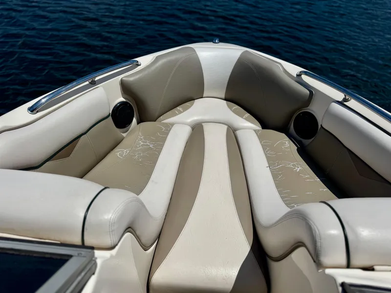 Slide: The Image of 2005 Tigé 24V boat interior with beige and white seating on calm water. - 4