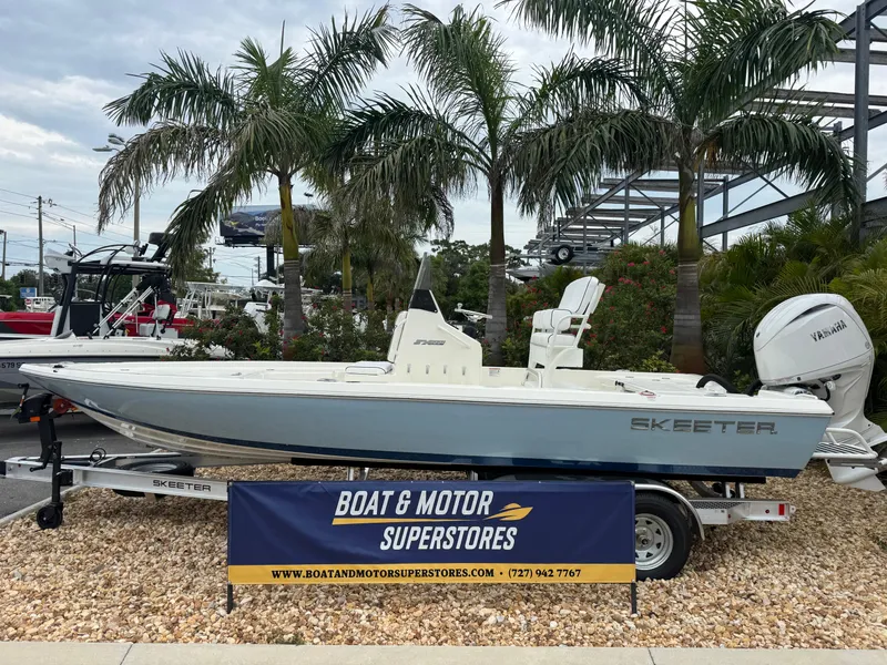 Slide: The Image of 2025 Skeeter SX 221 boat displayed at Boat & Motor Superstores, surrounded by palm trees. - 1