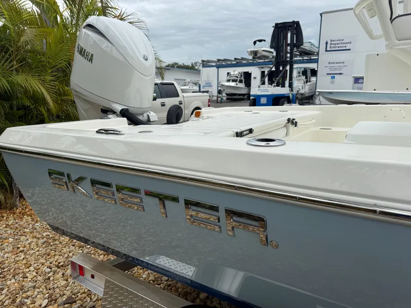 Slide: The Image of 2025 Skeeter SX 221 boat with Yamaha motor, parked on gravel near palm trees. - 11