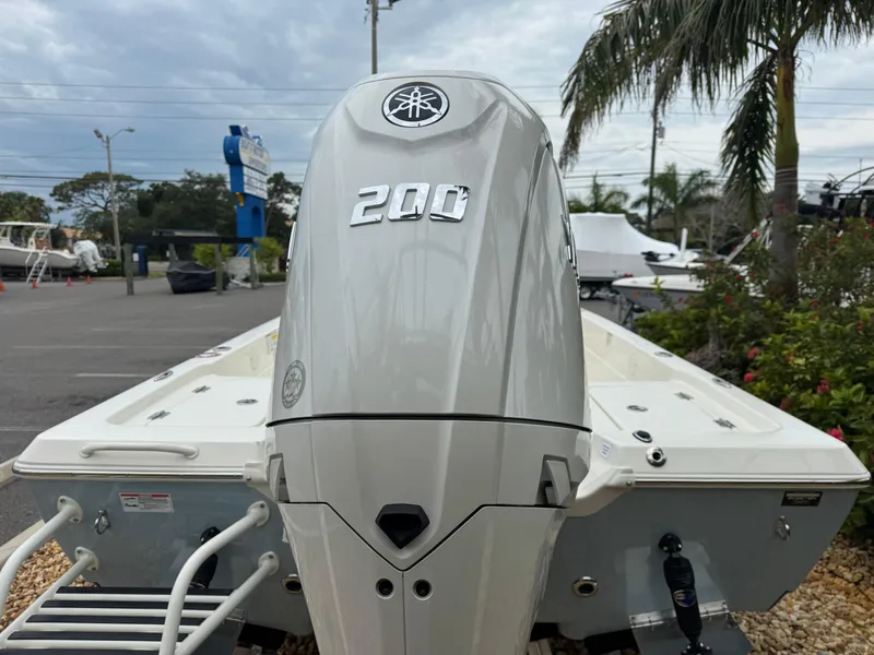 Slide: The Image of 2025 Skeeter SX 221 boat with Yamaha 200 outboard motor, parked outdoors. - 14