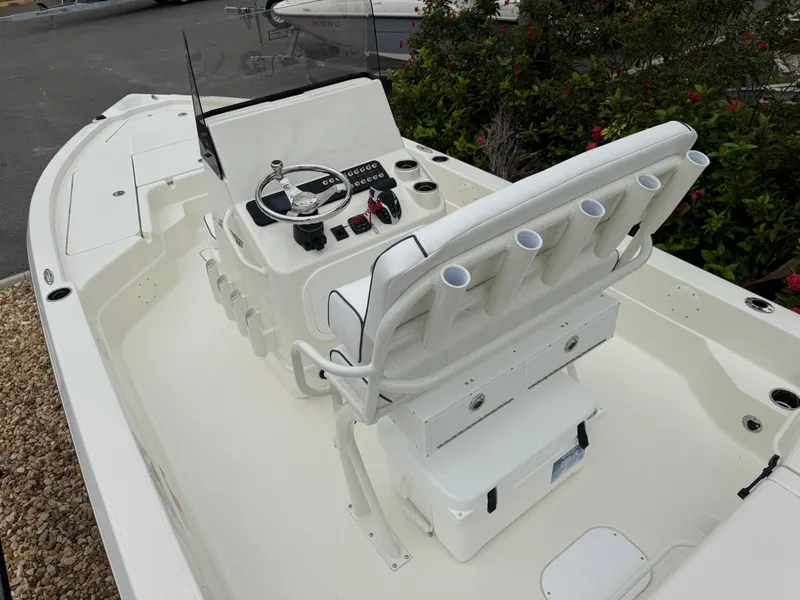 Slide: The Image of 2025 Skeeter SX 221 boat interior with steering console and seating, featuring rod holders. - 17