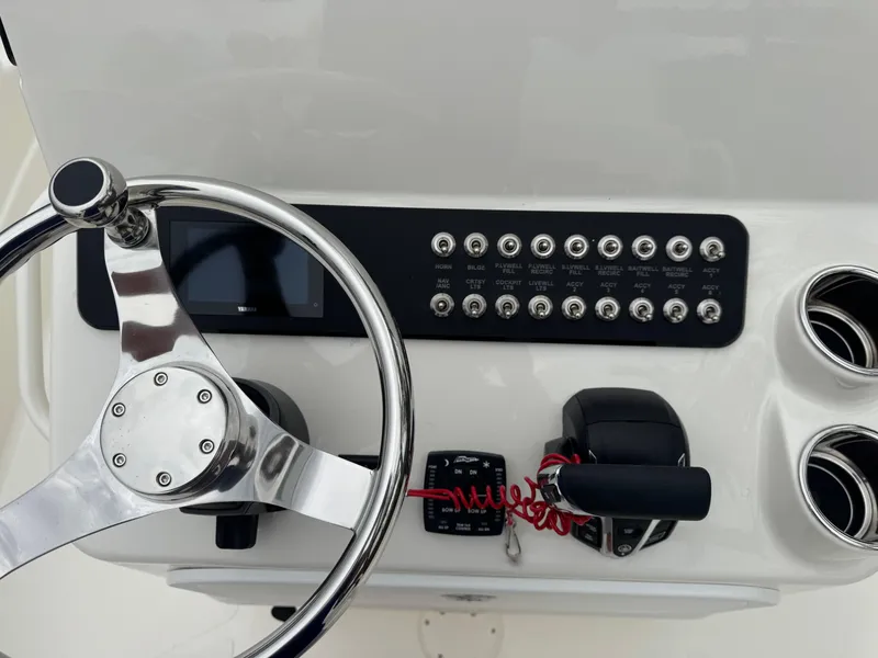 Slide: The Image of 2025 Skeeter SX 221 boat dashboard with steering wheel and control panel. - 25