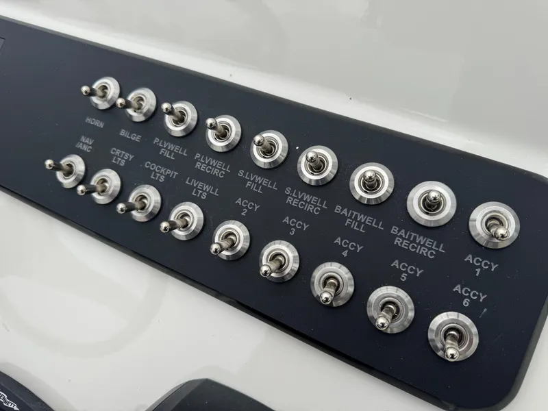 Slide: The Image of Control panel with switches on a 2025 Skeeter SX 221 boat. - 26