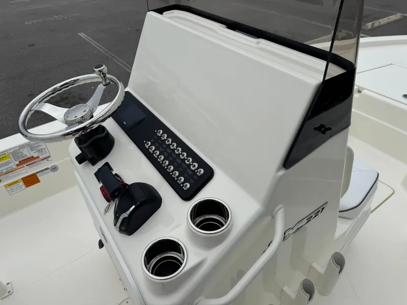 Slide: The Image of 2025 Skeeter SX 221 boat console with steering wheel and control panel. - 27