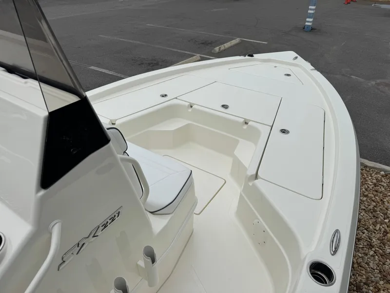 Slide: The Image of 2025 Skeeter SX 221 boat, white deck, spacious seating, parked in a lot. - 28