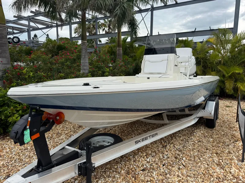 Slide: The Image of 2025 Skeeter SX 221 boat on trailer, surrounded by tropical plants. - 3