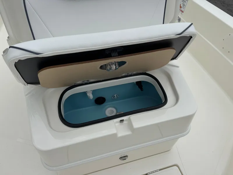 Slide: The Image of 2025 Skeeter SX 221 boat livewell with open lid, showcasing interior features. - 34