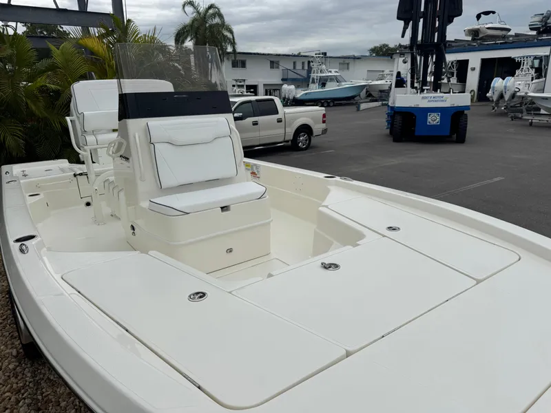 Slide: The Image of 2025 Skeeter SX 221 boat in marina, showcasing sleek design and spacious deck. - 7