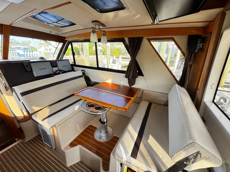 Slide: The Image of Interior of 2014 Cutwater 30 Sedan LE with seating and table, featuring modern design. - 11