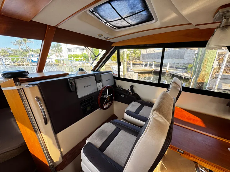 Slide: The Image of Interior of 2014 Cutwater 30 Sedan LE boat with helm and seating area. - 12