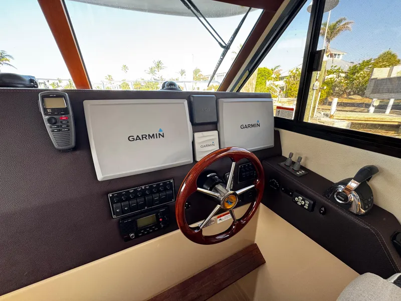 Slide: The Image of 2014 Cutwater 30 Sedan LE helm with Garmin navigation system and wooden steering wheel. - 13