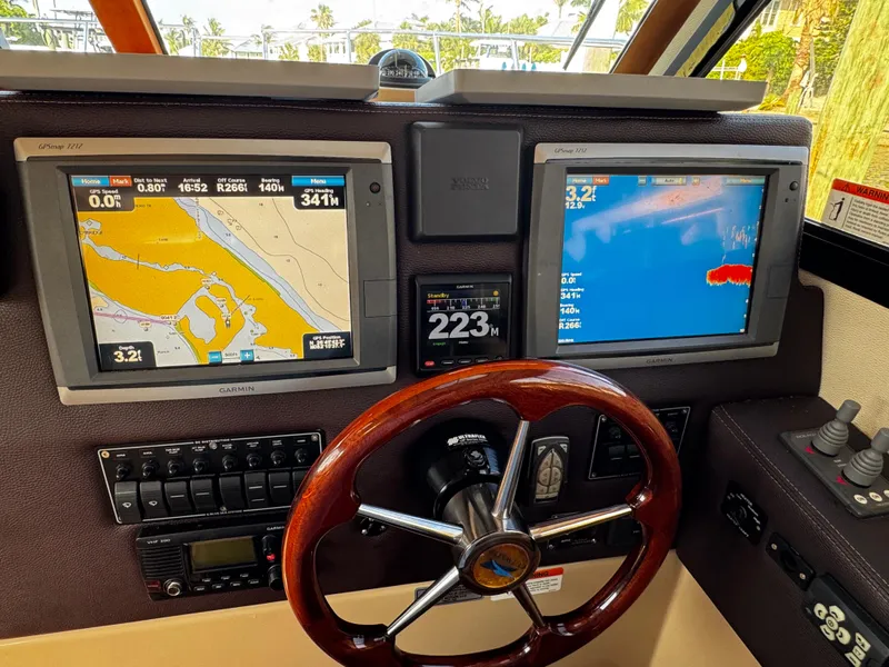 Slide: The Image of Dashboard of 2014 Cutwater 30 Sedan LE with navigation screens and steering wheel. - 14