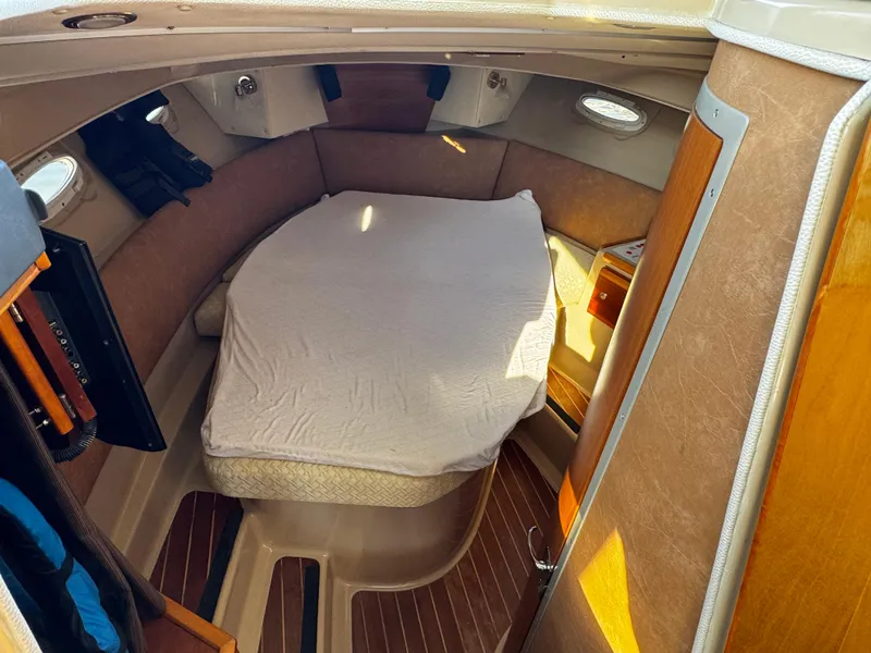 Slide: The Image of 2014 Cutwater 30 Sedan LE cabin interior with bed and wooden accents. - 16