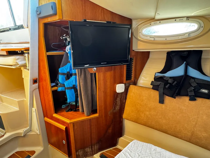 Slide: The Image of Interior of 2014 Cutwater 30 Sedan LE with TV, storage, and life jackets. - 17
