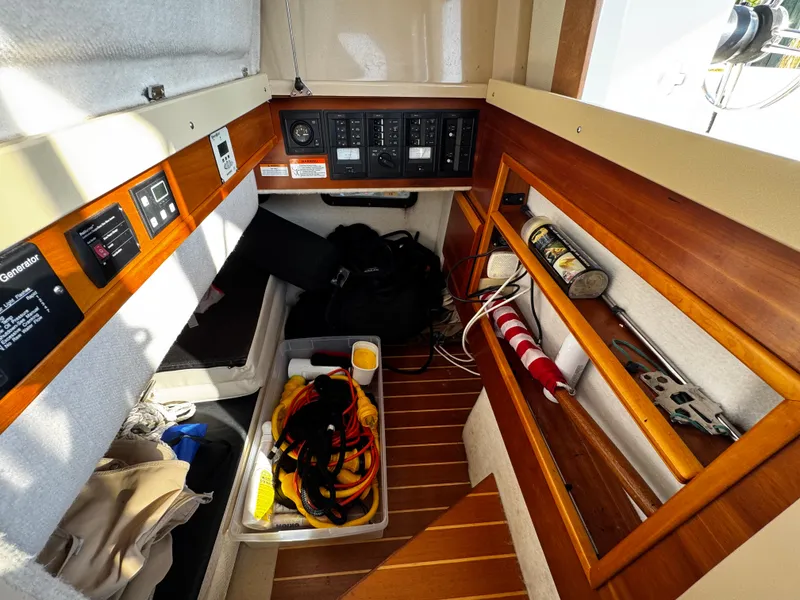 Slide: The Image of Interior of 2014 Cutwater 30 Sedan LE boat with storage and control panels. - 21