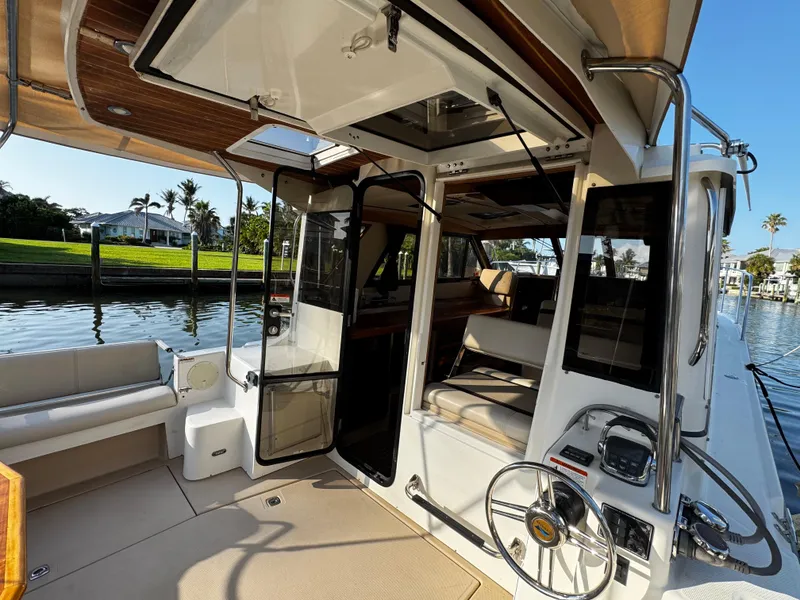 Slide: The Image of 2014 Cutwater 30 Sedan LE boat interior with open doors and steering wheel. - 4