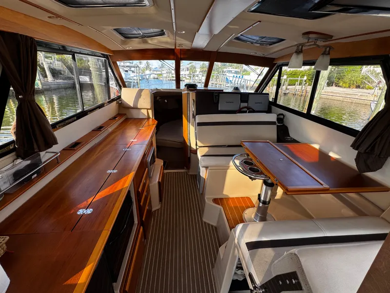 Slide: The Image of Interior of 2014 Cutwater 30 Sedan LE boat with wood accents and seating area. - 8