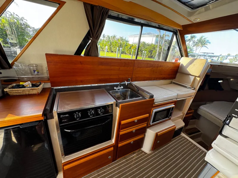 Slide: The Image of Interior of 2014 Cutwater 30 Sedan LE with kitchen and seating area. - 9