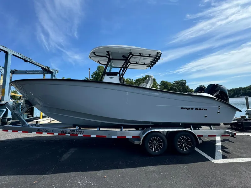 The Image of 2025 Cape Horn 27 XS boat on trailer, parked outdoors under clear blue sky. - 0