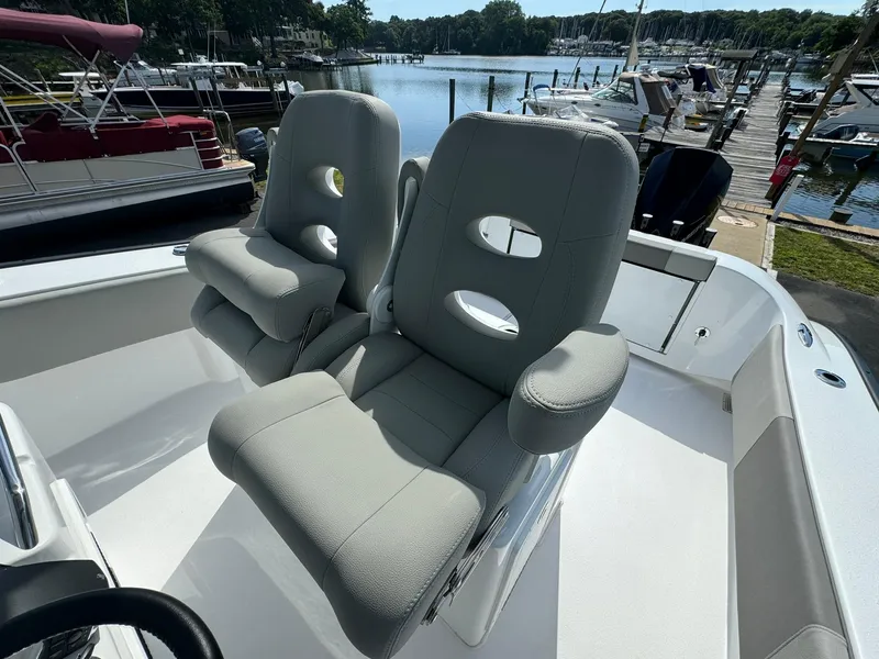 Slide: The Image of 2025 Cape Horn 27 XS boat with comfortable seating at a marina. - 13