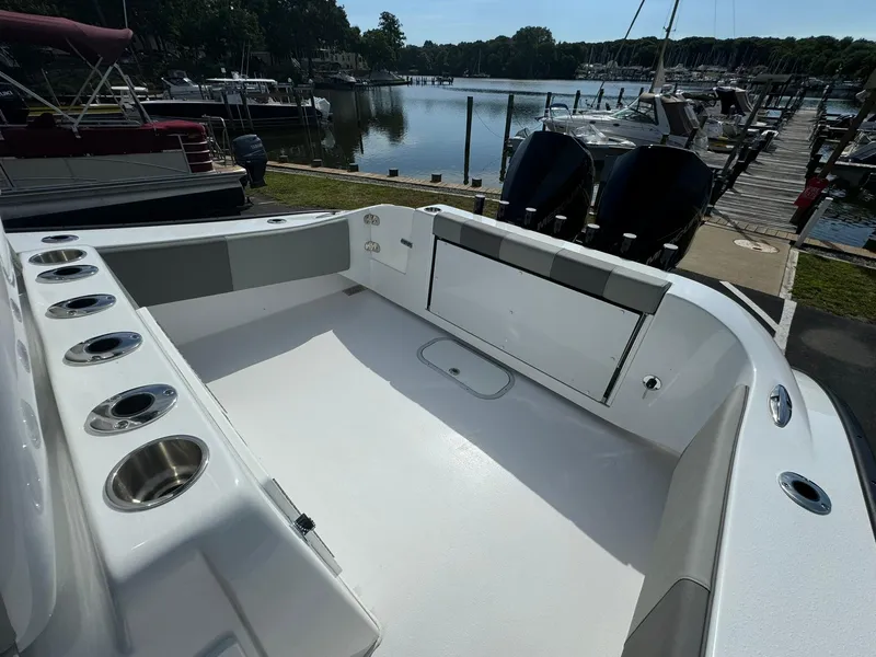 Slide: The Image of 2025 Cape Horn 27 XS boat interior with spacious deck and cup holders, docked at marina. - 14