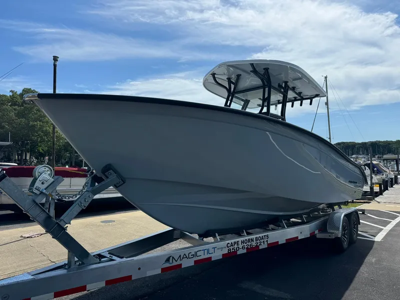 Slide: The Image of 2025 Cape Horn 27 XS boat on trailer at marina under clear sky. - 4