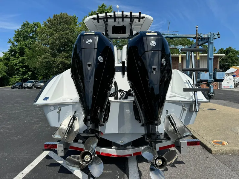 Slide: The Image of 2025 Cape Horn 27 XS boat with dual outboard engines, parked on a trailer. - 7