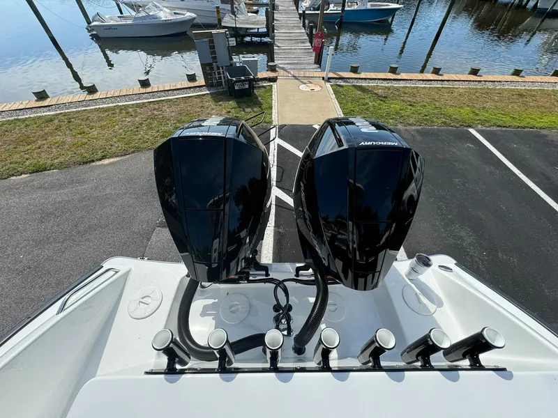 Slide: The Image of 2025 Cape Horn 27 XS boat with dual outboard engines at a marina dock. - 9