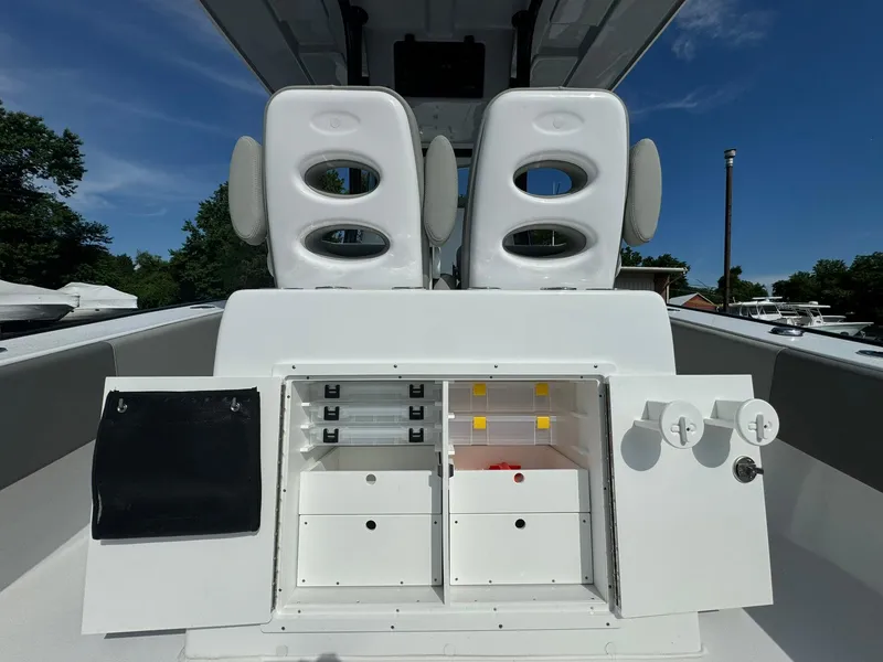 Slide: The Image of 2025 Cape Horn 27 XS boat interior with storage compartments and dual seats. - 12