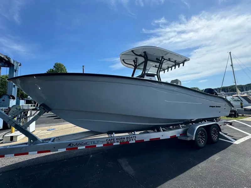 Slide: The Image of 2025 Cape Horn 27 XS boat on trailer under clear sky. - 5
