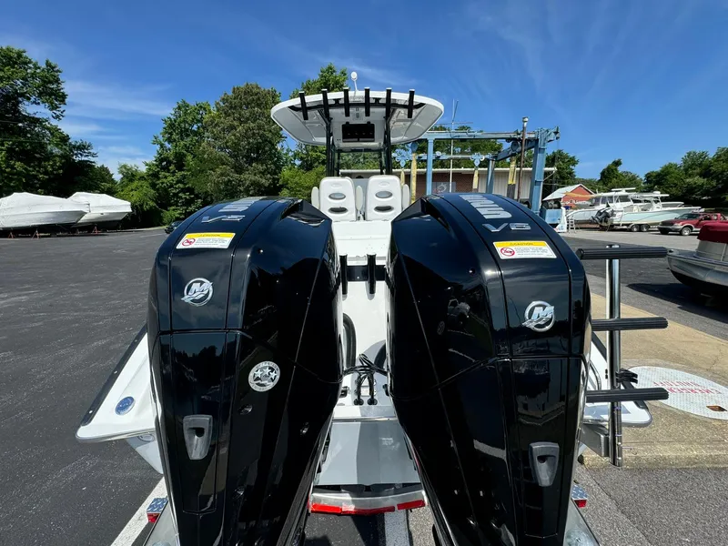 Slide: The Image of 2025 Cape Horn 27 XS boat with dual Mercury outboard engines, parked outdoors. - 8