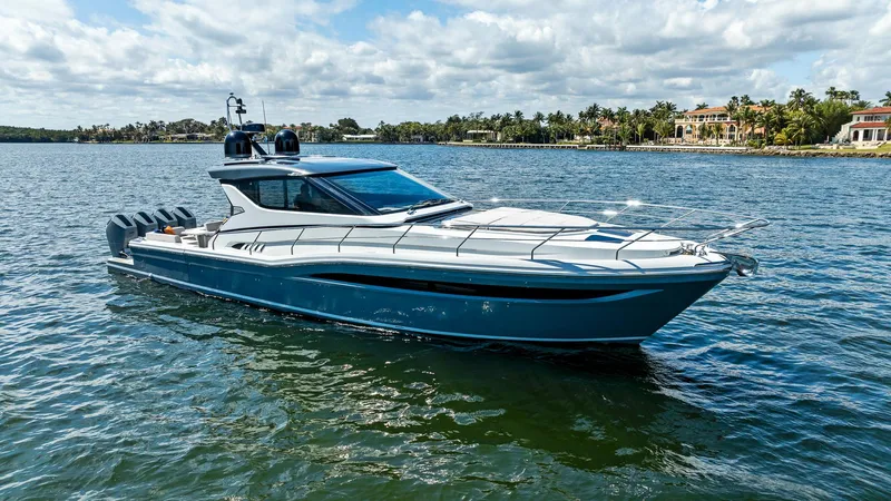 Slide: The Image of 2024 Uniesse Exuma HTC5p yacht on serene water, showcasing sleek design and luxury. - 0