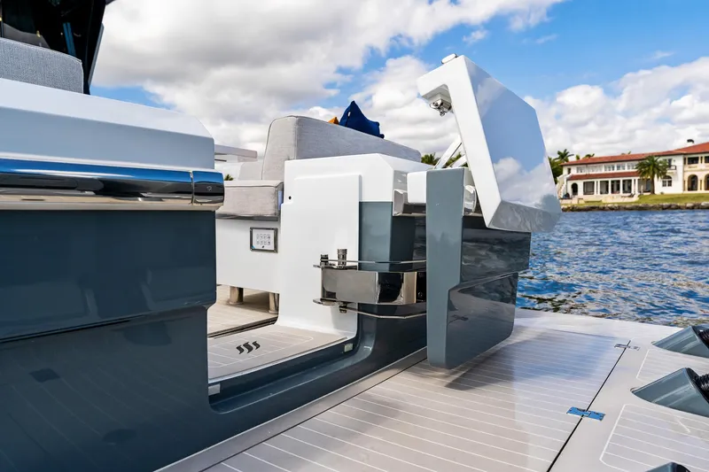 Slide: The Image of 2024 Uniesse Exuma HTC5p yacht deck with modern seating and water view. - 13