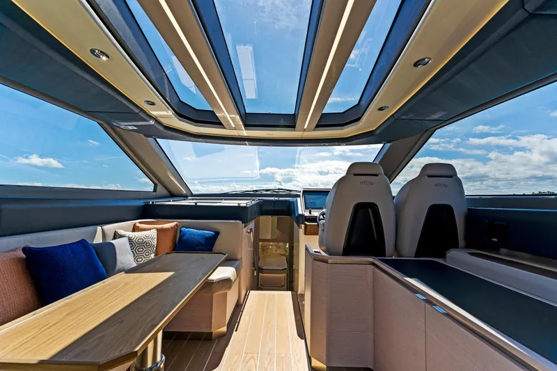 Slide: The Image of Luxurious interior of 2024 Uniesse Exuma HTC5p yacht with panoramic windows and elegant seating. - 15