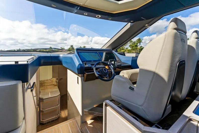 Slide: The Image of 2024 Uniesse Exuma HTC5p yacht interior with modern helm and luxurious seating. - 17