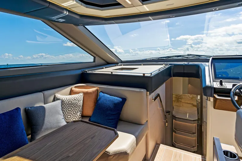 Slide: The Image of 2024 Uniesse Exuma HTC5p yacht interior with plush seating and modern design. - 18