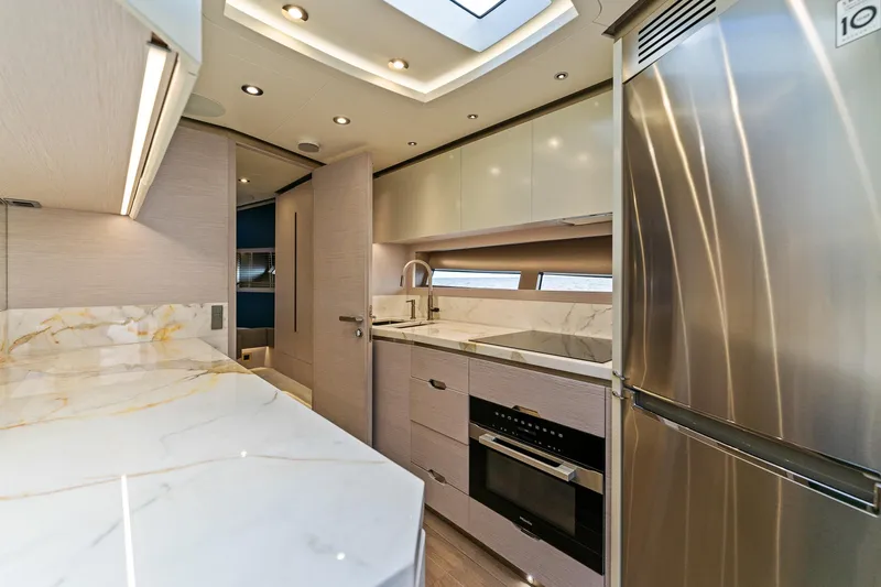 Slide: The Image of Luxurious 2024 Uniesse Exuma HTC5p yacht kitchen with modern appliances and elegant marble countertops. - 19