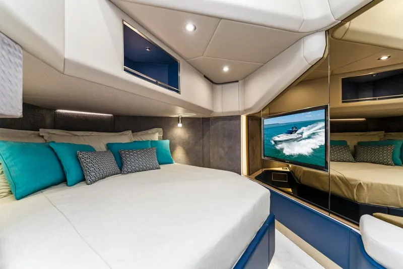 Slide: The Image of Luxurious 2024 Uniesse Exuma HTC5p yacht interior with modern bedroom and TV. - 22