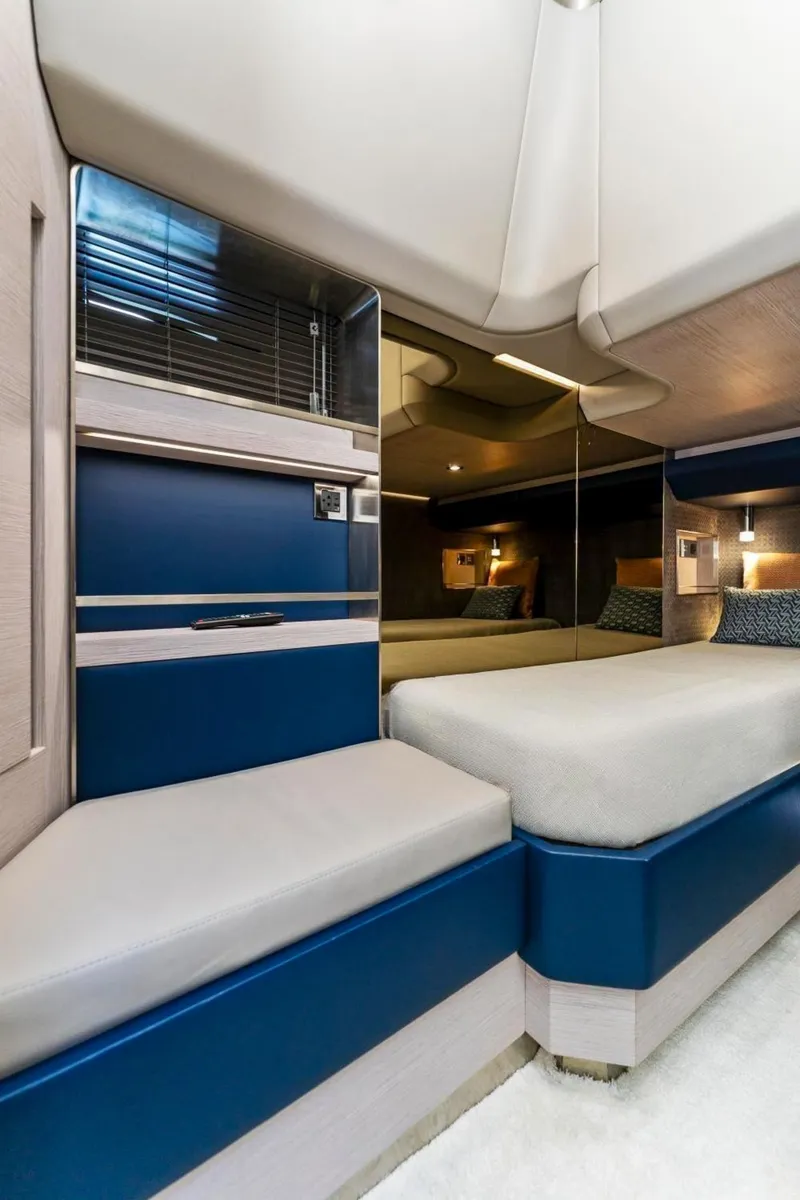 Slide: The Image of 2024 Uniesse Exuma HTC5p yacht interior with modern blue and beige design. - 25