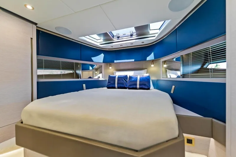 Slide: The Image of Luxurious bedroom interior of 2024 Uniesse Exuma HTC5p yacht with modern blue accents. - 28