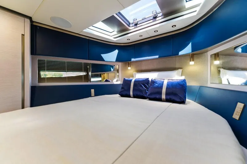 Slide: The Image of Luxurious interior of 2024 Uniesse Exuma HTC5p yacht with elegant bedding and skylight. - 29