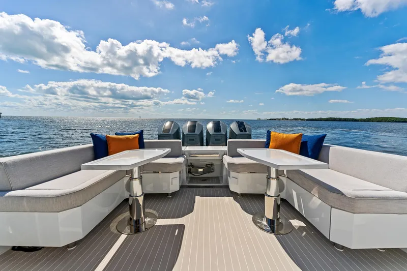 Slide: The Image of 2024 Uniesse Exuma HTC5p yacht deck with seating, tables, and ocean view. - 3