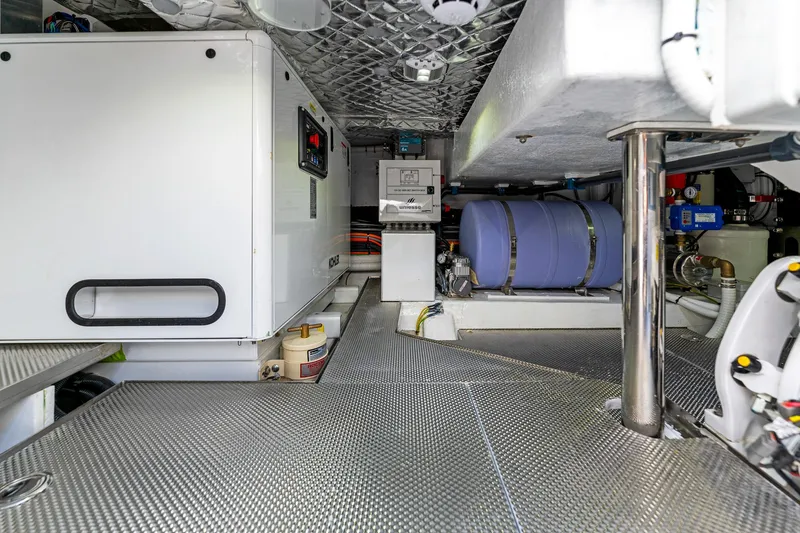 Slide: The Image of Engine room of 2024 Uniesse Exuma HTC5p yacht with modern equipment and metallic flooring. - 35