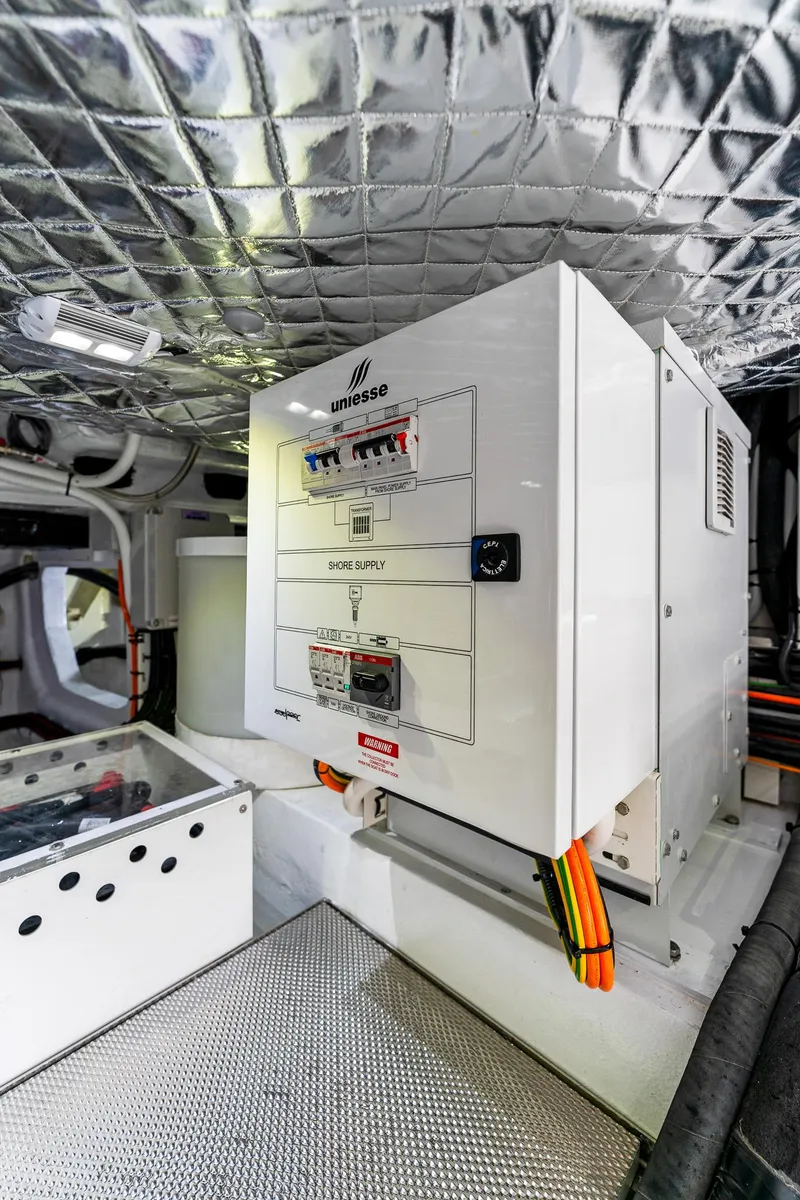 Slide: The Image of 2024 Uniesse Exuma HTC5p engine room with control panel and insulated ceiling. - 37