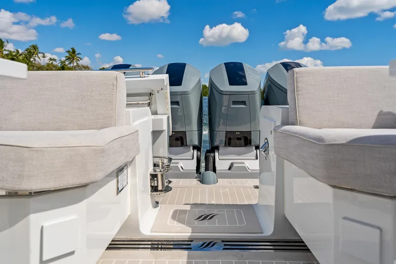 Slide: The Image of 2024 Uniesse Exuma HTC5p yacht deck with seating and outboard motors. - 4