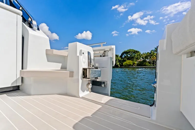 Slide: The Image of 2024 Uniesse Exuma HTC5p yacht deck with scenic water view. - 7