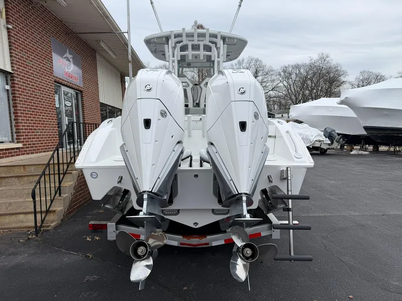 Slide: The Image of 2025 Cape Horn 28 XS boat with dual outboard engines, parked outdoors. - 22