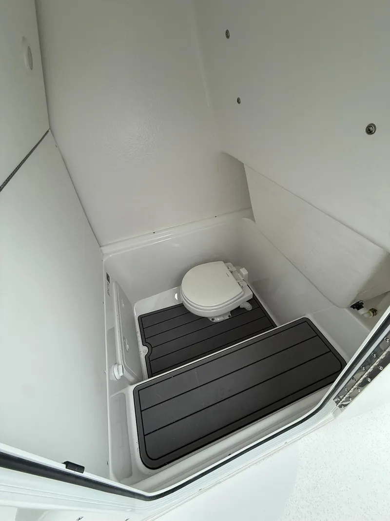 Slide: The Image of 2025 Cape Horn 28 XS boat interior with compact marine toilet and non-slip flooring. - 6